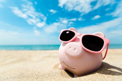 piggy bank on a beach in the sun