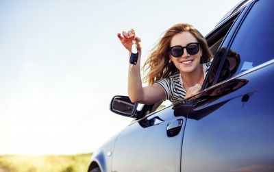 young woman driving new car