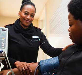 health care worker adjusting blood pressure cuff