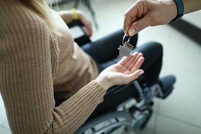 female veteran in wheelchair being given her house key